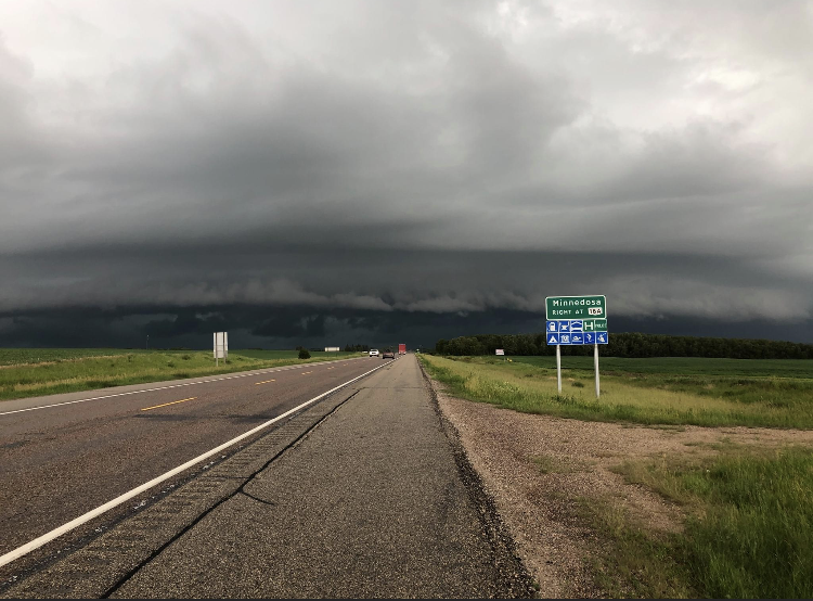 A severe storm approaching the Minnedosa highway sign