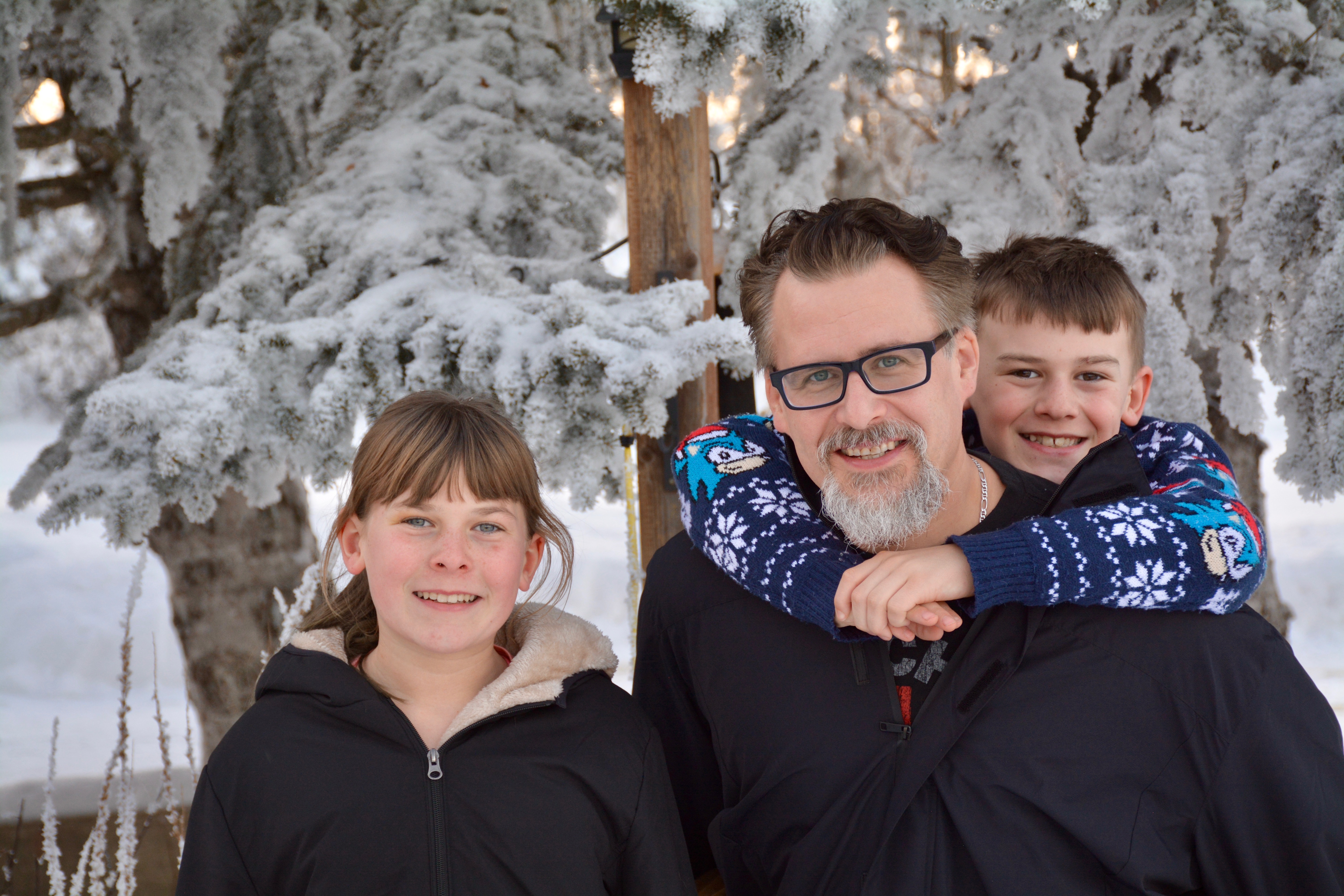 Tom Mathews outdoors in winter with his son